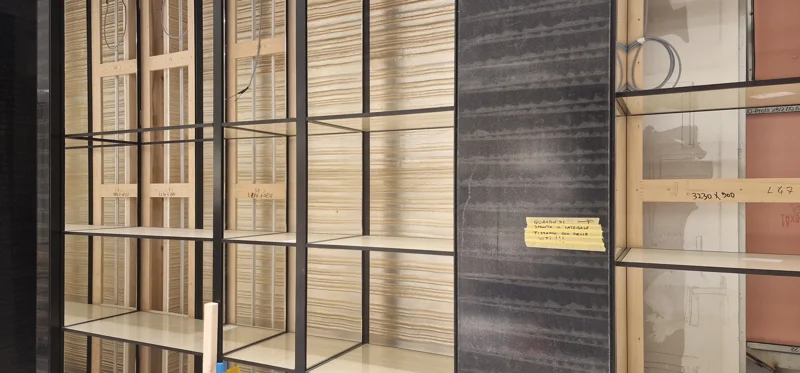 Metal shelving framework on wooden back panel during retail shelving system installation